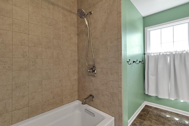 full bath featuring baseboards and shower / bathtub combination