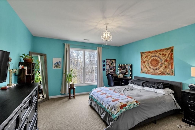 carpeted bedroom featuring visible vents, baseboards, and a chandelier
