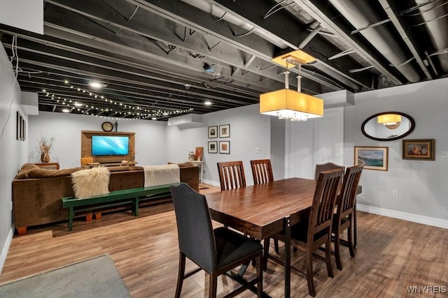 dining space featuring baseboards and wood finished floors
