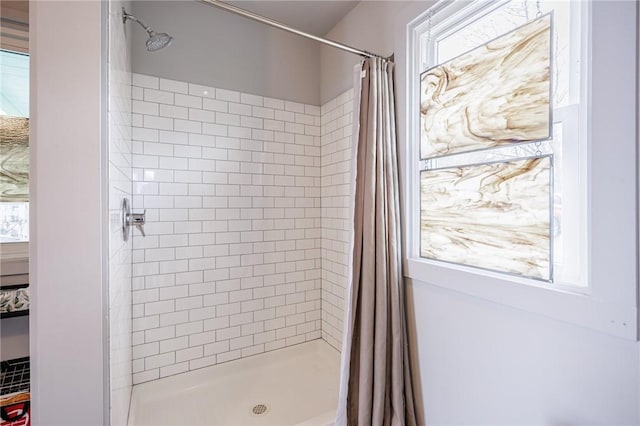 bathroom featuring plenty of natural light and a stall shower