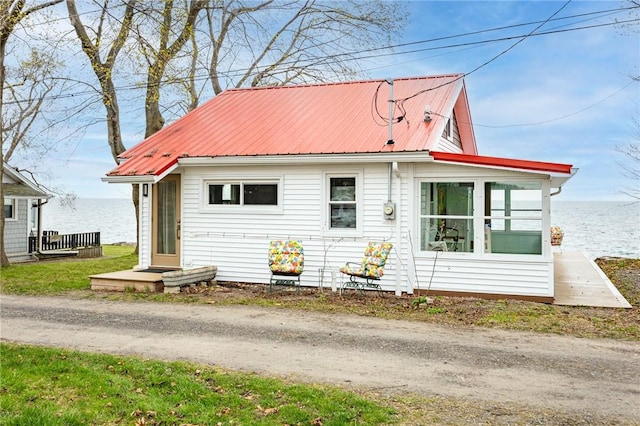 view of front of house with a water view and metal roof