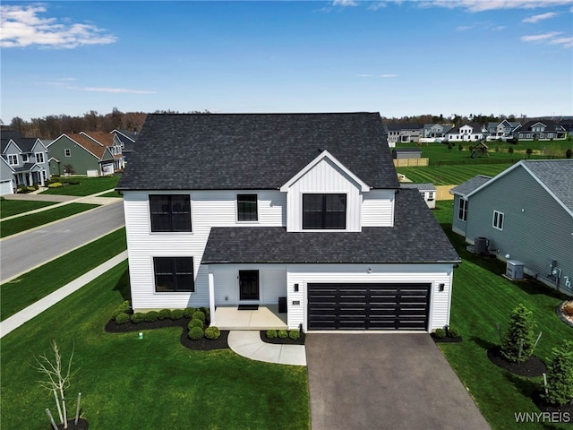 view of front of house with a residential view, driveway, and a front yard