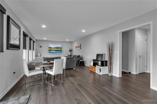 dining area with recessed lighting, dark wood finished floors, and baseboards