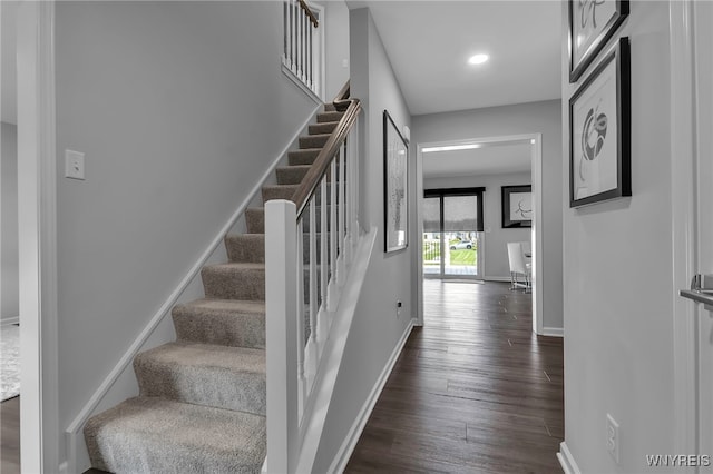 staircase with baseboards, recessed lighting, and wood finished floors
