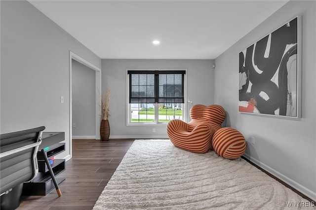 living area featuring baseboards, recessed lighting, and dark wood finished floors