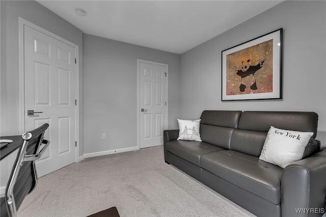 carpeted living area with baseboards