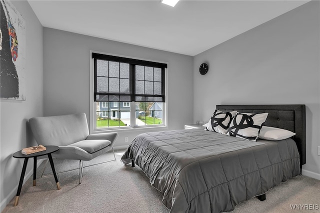 bedroom with baseboards and carpet