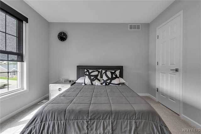 bedroom with baseboards, visible vents, and carpet