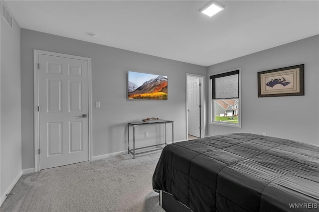 carpeted bedroom with baseboards and visible vents
