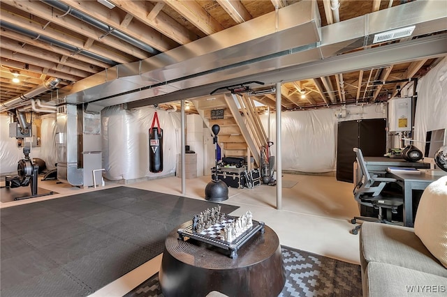 unfinished basement featuring visible vents, heating unit, and tankless water heater