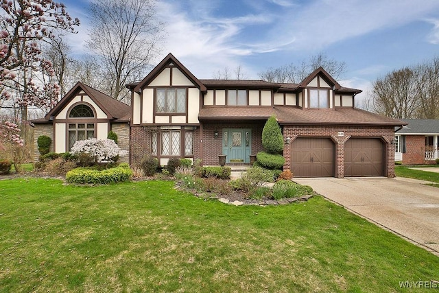 tudor house featuring concrete driveway, brick siding, a front yard, and a garage