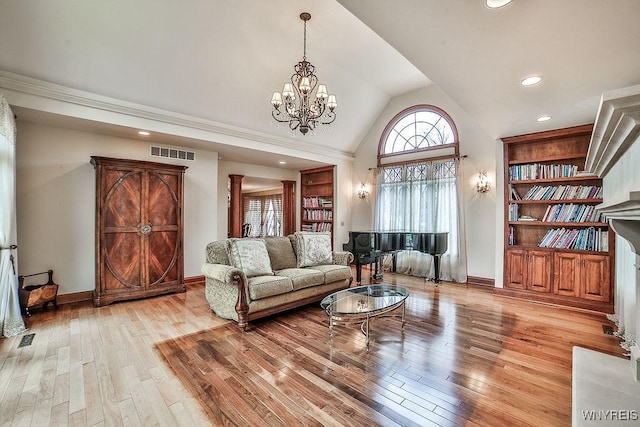 living room with visible vents, high vaulted ceiling, and hardwood / wood-style flooring