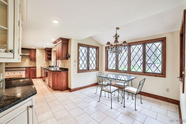 dining area featuring light tile patterned floors, baseboards, lofted ceiling, and a chandelier