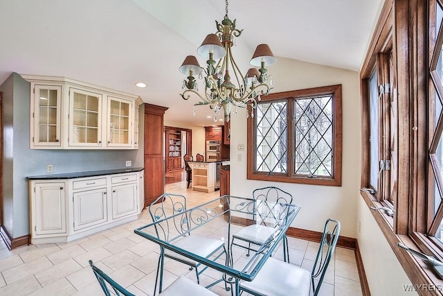 dining area featuring light tile patterned floors, baseboards, lofted ceiling, an inviting chandelier, and recessed lighting