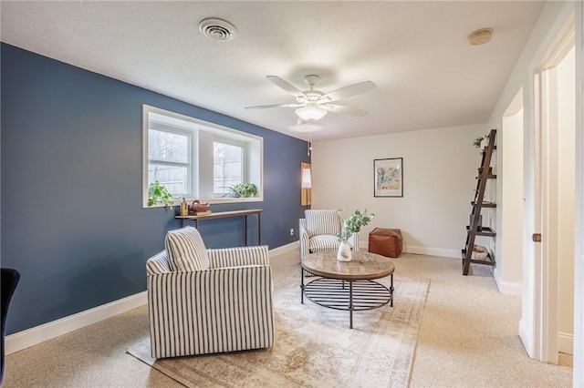 sitting room with a ceiling fan, baseboards, and visible vents