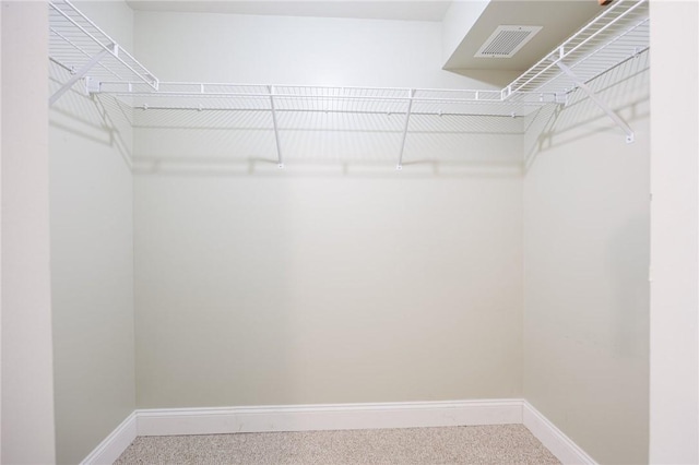 walk in closet featuring carpet floors and visible vents
