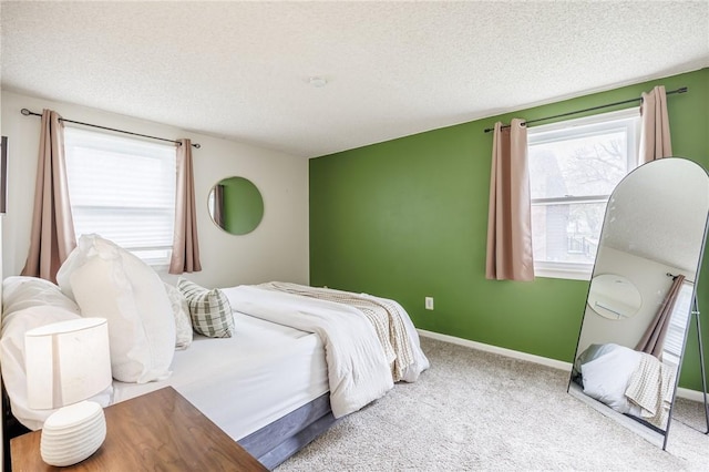 carpeted bedroom featuring baseboards and a textured ceiling