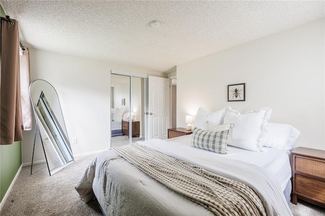 carpeted bedroom with baseboards, a closet, and a textured ceiling