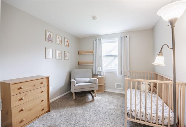 carpeted bedroom featuring baseboards, a nursery area, and visible vents