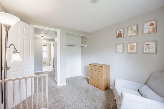 living area with baseboards and carpet