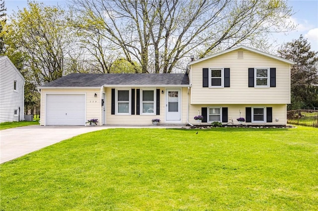 split level home with a garage, driveway, and a front yard