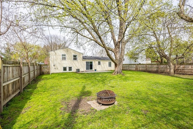 view of yard featuring a fire pit, a fenced backyard, and a patio area
