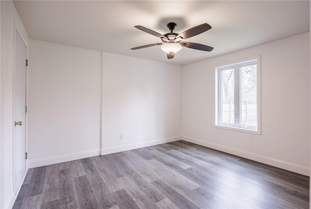 unfurnished room with baseboards, a ceiling fan, and wood finished floors