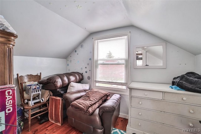 bedroom with vaulted ceiling and wood finished floors