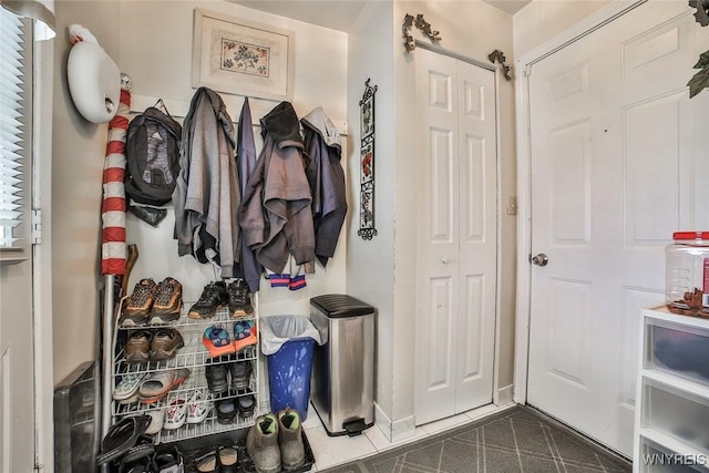 mudroom featuring dark tile patterned flooring