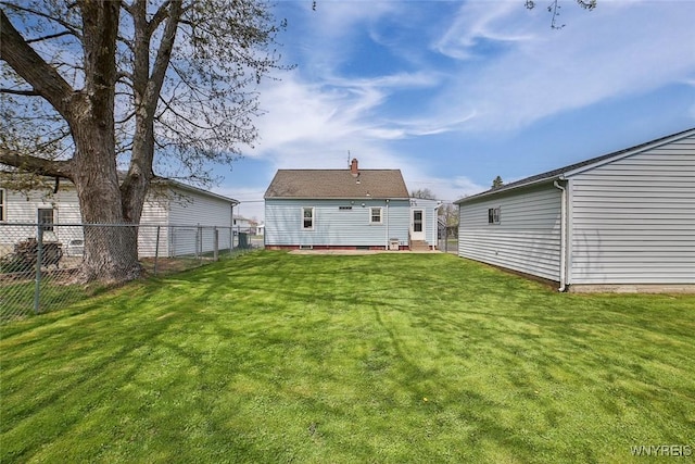 rear view of property with a lawn, fence, and entry steps