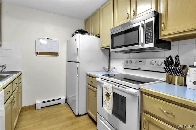 kitchen featuring white appliances, baseboard heating, light wood-type flooring, light countertops, and tasteful backsplash