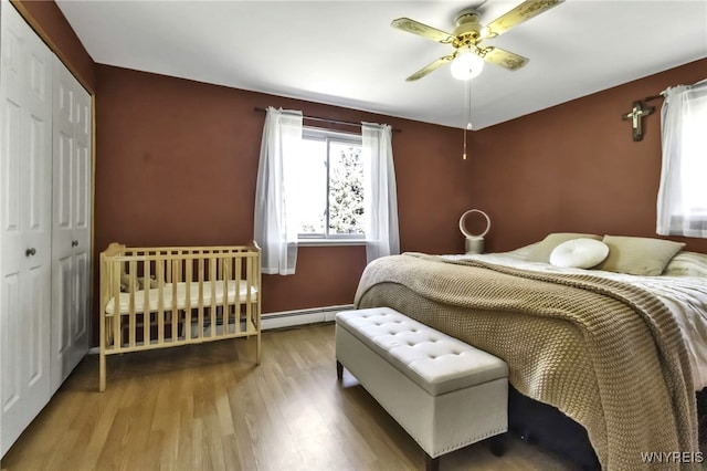 bedroom with a closet, ceiling fan, and wood finished floors
