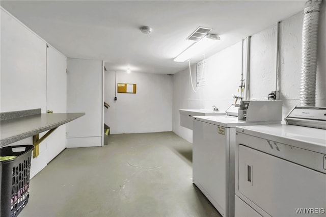 laundry area with washing machine and clothes dryer, laundry area, visible vents, and a sink