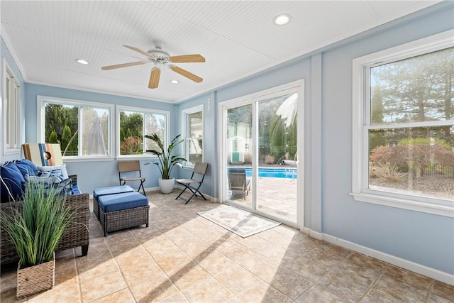 sunroom featuring baseboards and a wealth of natural light