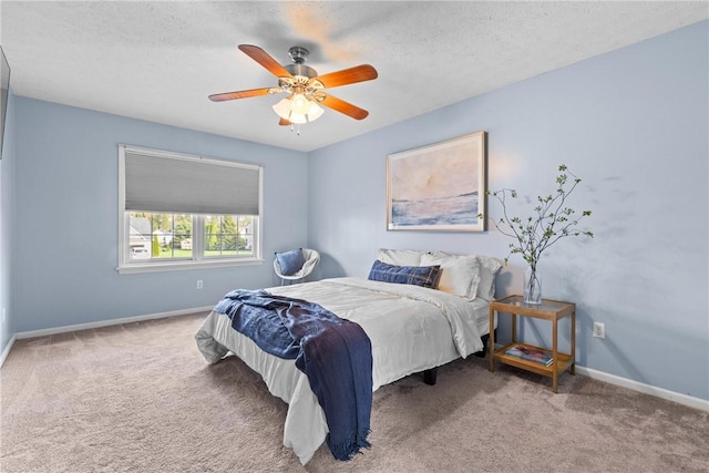 bedroom with baseboards, a ceiling fan, carpet flooring, and a textured ceiling