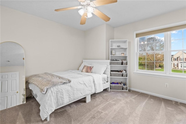 bedroom featuring carpet floors, baseboards, and ceiling fan