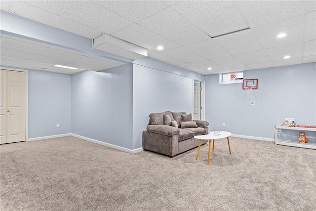 carpeted living room featuring baseboards, recessed lighting, and a paneled ceiling