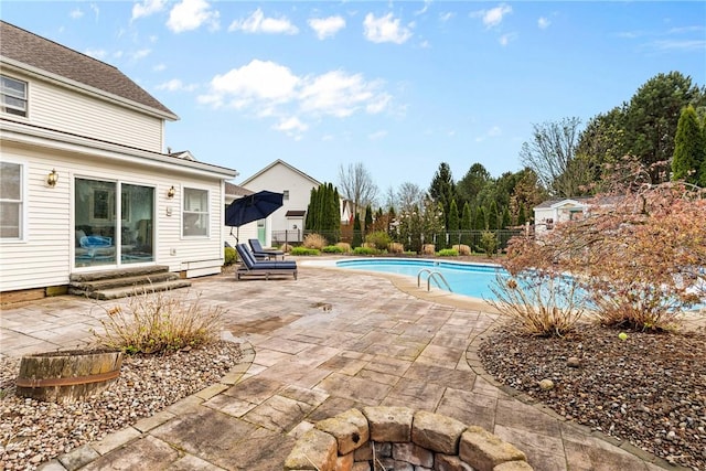 view of swimming pool with fence, a fenced in pool, a patio, and entry steps