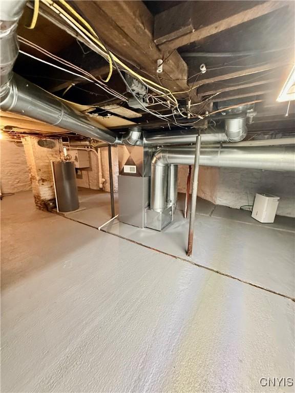 unfinished below grade area featuring heating unit and water heater