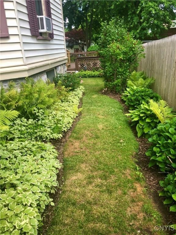 view of yard featuring fence and cooling unit