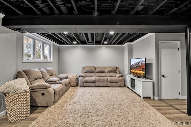 living area featuring baseboards and light wood-type flooring