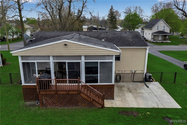 back of house with a gate, a patio, a shingled roof, and a sunroom