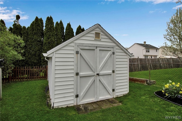 view of shed with a fenced backyard