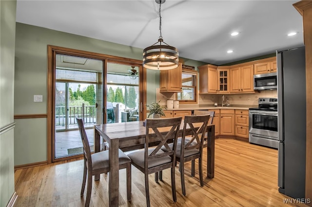 dining area with recessed lighting, baseboards, a wealth of natural light, and light wood-type flooring