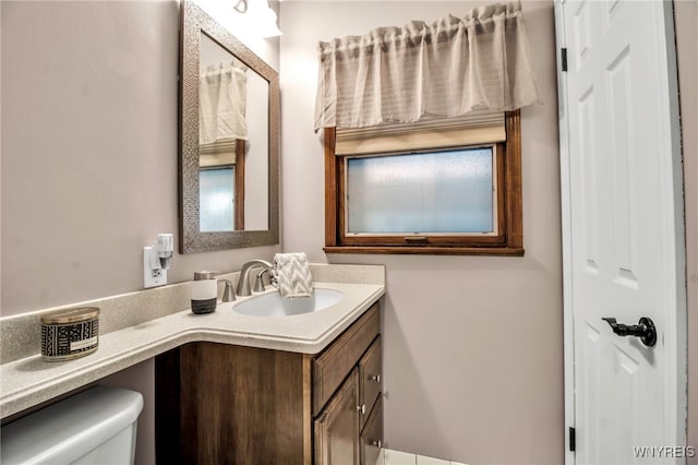 bathroom featuring vanity and toilet