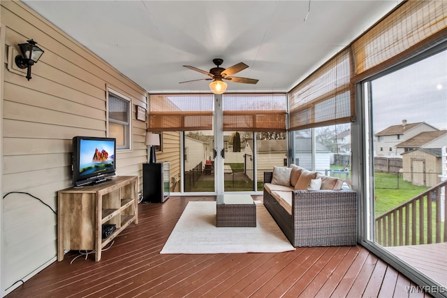 sunroom / solarium featuring ceiling fan and an outdoor hangout area