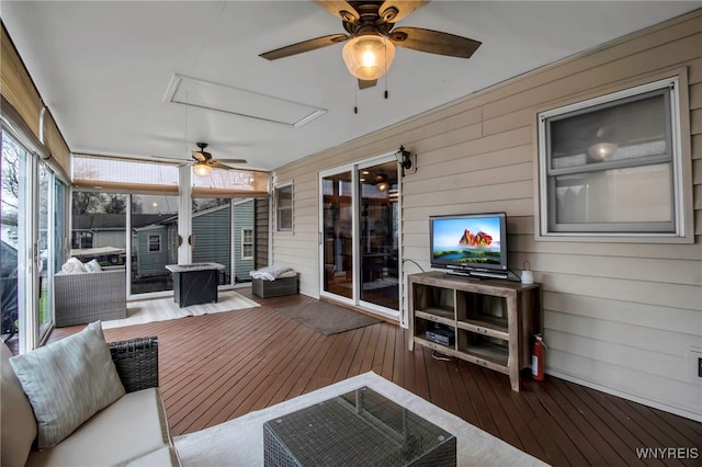 sunroom featuring a ceiling fan