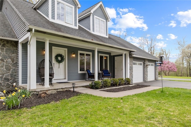 cape cod house with a shingled roof, a front lawn, stone siding, covered porch, and driveway