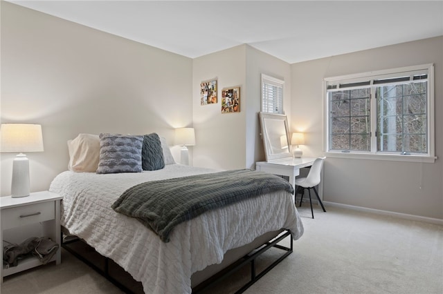 carpeted bedroom featuring baseboards