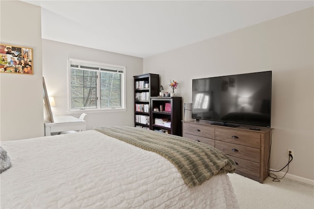 bedroom featuring baseboards and carpet